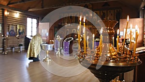 Burning candles. Secret rite of baptism in the orthodox church on the background. Close up shot.