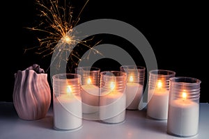 Burning candles on a white background next to the fireworks. Obon festival. Diwali festival