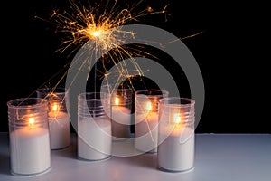 Burning candles on a white background next to the fireworks. Obon festival. Diwali festival