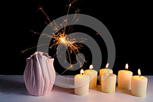 Burning candles on a white background next to the fireworks. Obon festival. Diwali festival