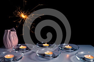 Burning candles on a white background next to the fireworks. Obon festival. Diwali festival