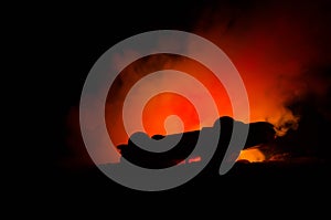 Burning car on a dark background. Car catching fire, after act of vandalism or road indicent