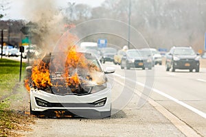 Burning car on fire on a highway road accident