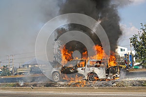 Burning car on the highway road