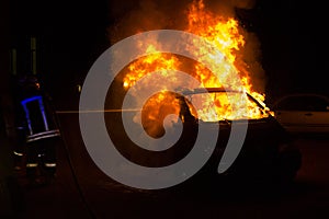 Burning car on the road in the night