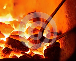 Burning charcoal in the background