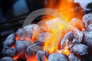 Burning charcoal briquettes closeup photo