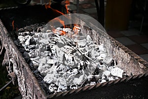 Burning charcoal and log in a BBQ brazier