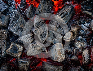 Burning charcoal top view for background. The texture of embers in close-up