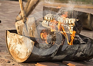 Burning charcoal from wood in a barbecue boiler