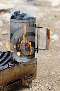 Burning Chimney Starter with Charcoal