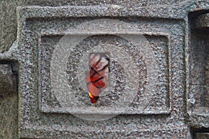 Burning coals and fire through a crack in the cast iron lid of the furnace. Old rusty furnace damper