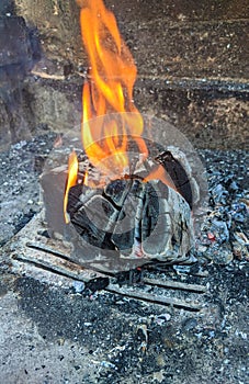 Burning coals, wood and ashes in the hot oven