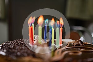 Burning colored candles on a holiday cake, the child`s tenth anniversary