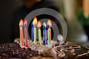 Burning colored candles on a holiday cake, the child`s tenth anniversary