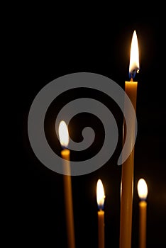 Burning in the dark taper candles photo