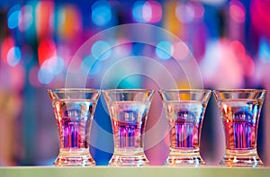 Burning drinks in shot glasses on a bar counter