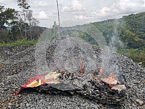 Burning fake money praying God Chinese in Penampang, Sabah. Borneo.