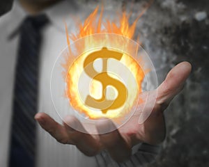 Burning fire ball of dollar sign in businessman's hand