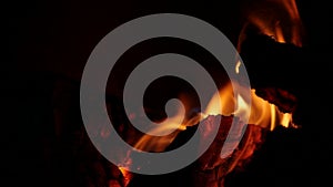 Burning Fire In a brick Fireplace. Wood And Embers In The Fireplace. Furnace with medium size flames. Slow motion of