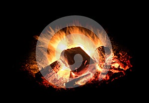 Burning fire with embers in front of black background