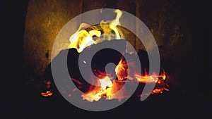 Burning fire in fireplace. Reverse slow motion firewood burns in the furnace and crack
