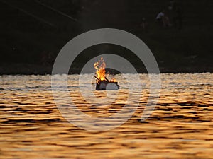 Burning Fire Flames on Raft in Water on River during Sunset