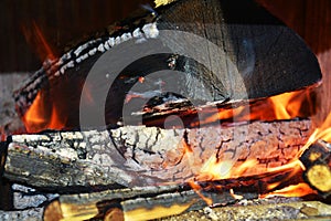 Burning fire, hot flames and wooden oven. Wood dark hard logs burning, orange flames and hot temperature