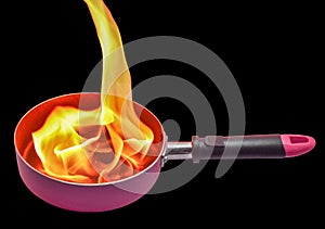 Burning fire pan on a black background