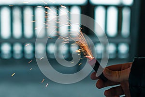 Burning Firecracker with Sparks. Guy Holding a Petard in a Hand