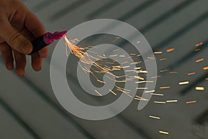 Burning Firecracker with Sparks. Guy Holding a Petard in a Hand