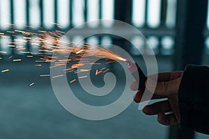 Burning Firecracker with Sparks. Guy Holding a Petard in a Hand