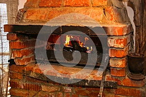 Burning firewood in brick furnace