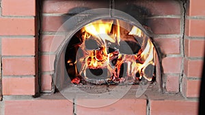 Burning firewood in brick oven with wood heating.