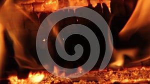 Burning firewood coal closeup in the fireplace.