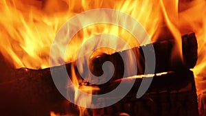 Burning firewood coal closeup in the fireplace.