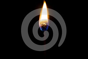 Burning flame on a black matchstick