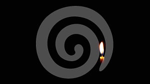 Burning Flame of a Church Candle on Isolated Black Background. Slow motion