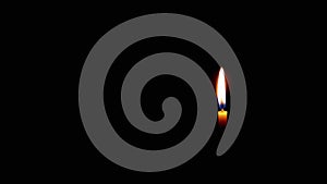 Burning Flame of a Church Candle on Isolated Black Background. Slow motion