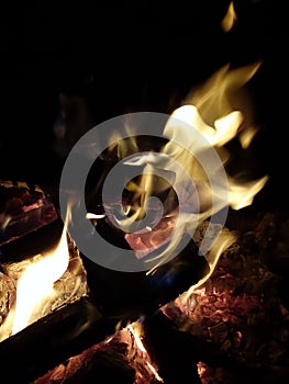 Burning flames on wood logs on a fire pit