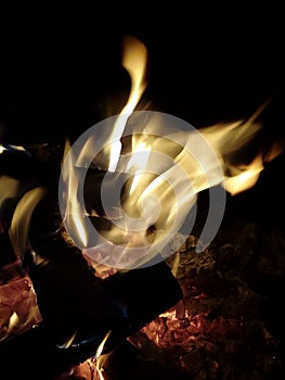 Burning flames on wood logs on a fire pit