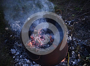 Burning garbage in the tank. Incineration of garbage in an iron bucket. Flames