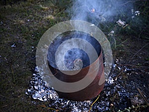 Burning garbage in the tank. Incineration of garbage in an iron bucket. Flames