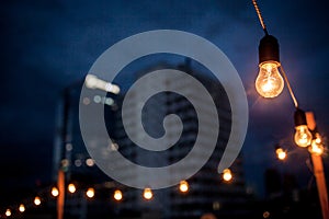 Burning garlands garland on a wooden background. Light bulbs on wooden background