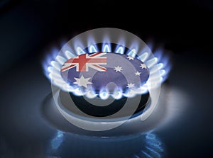 Burning gas burner of a home stove in the middle of which is the flag of the country of Australia. Gas import and export delivery