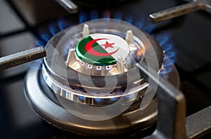 A burning gas burner of a home stove, in the middle of which a flag is depicted - Algeria