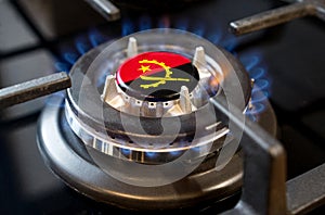 A burning gas burner of a home stove, in the middle of which a flag is depicted - Angola