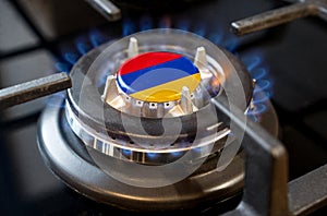 A burning gas burner of a home stove, in the middle of which a flag is depicted - Armenia