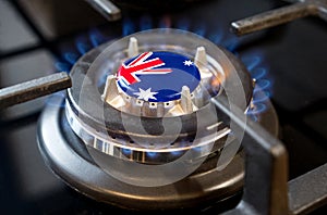 A burning gas burner of a home stove, in the middle of which a flag is depicted - Australia