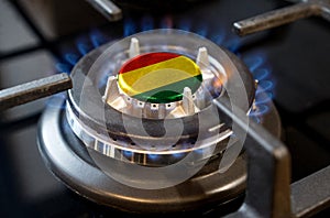 A burning gas burner of a home stove, in the middle of which a flag is depicted - Bolivia